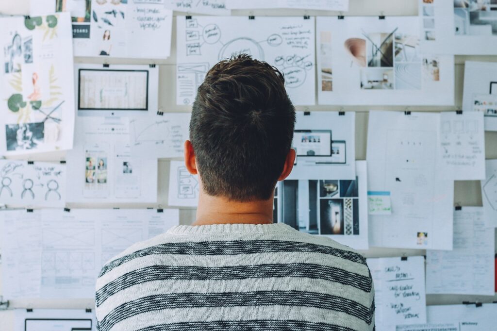 image showing a person looking a monthly plan pasted on the wall