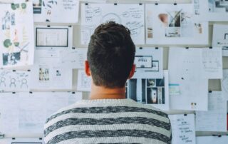 image showing a person looking a monthly plan pasted on the wall