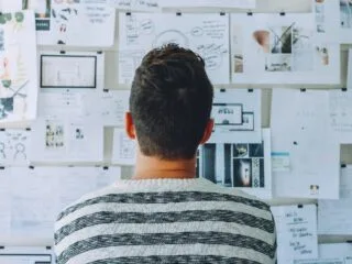 image showing a person looking a monthly plan pasted on the wall