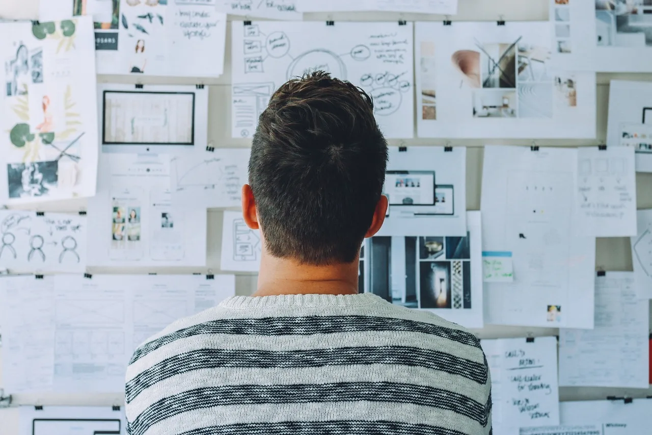 image showing a person looking a monthly plan pasted on the wall