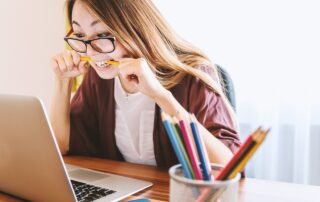 image showing a woman reviewing her study with a laptop. basically, looking for her self-improvement!