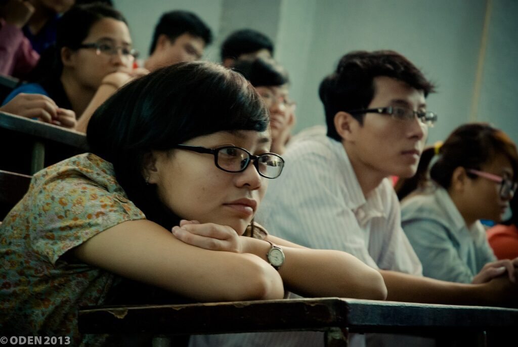 image showing students writing and listening in their class