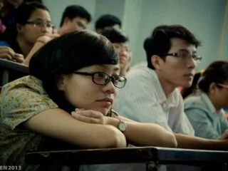 image showing students writing and listening in their class