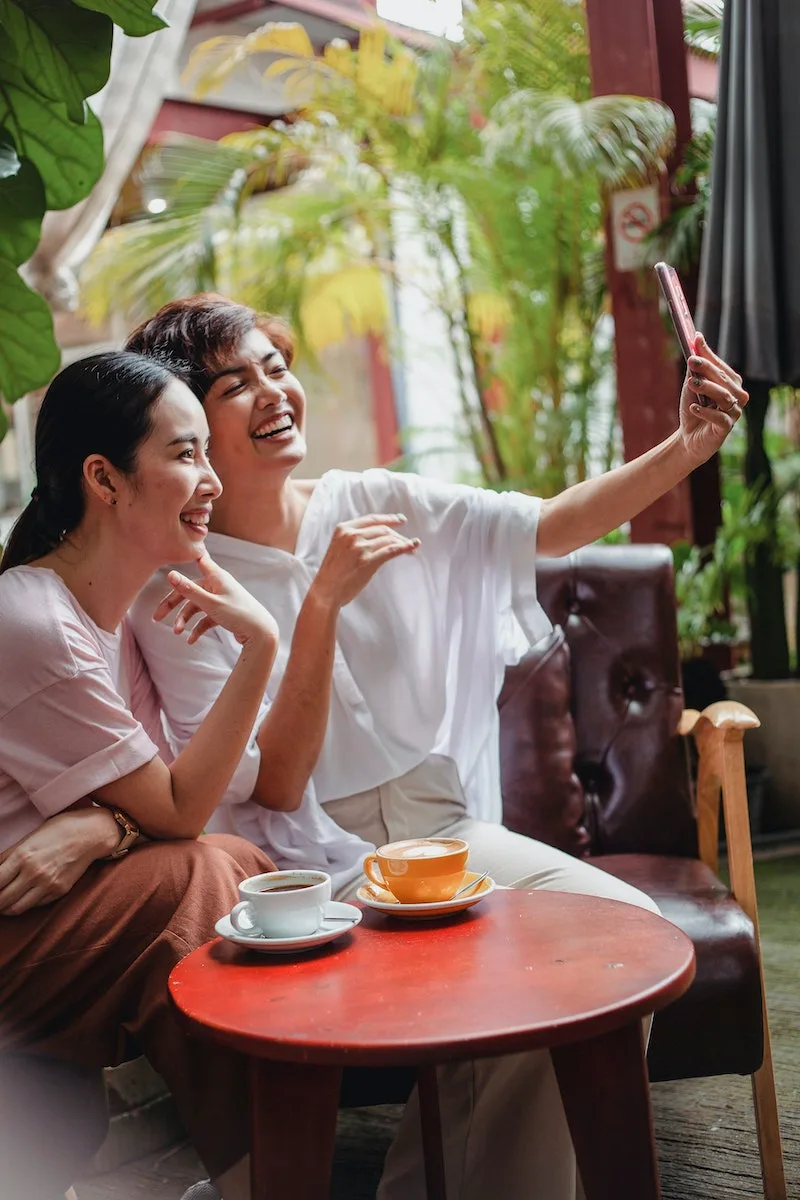 Cheerful friends resting in cafe
