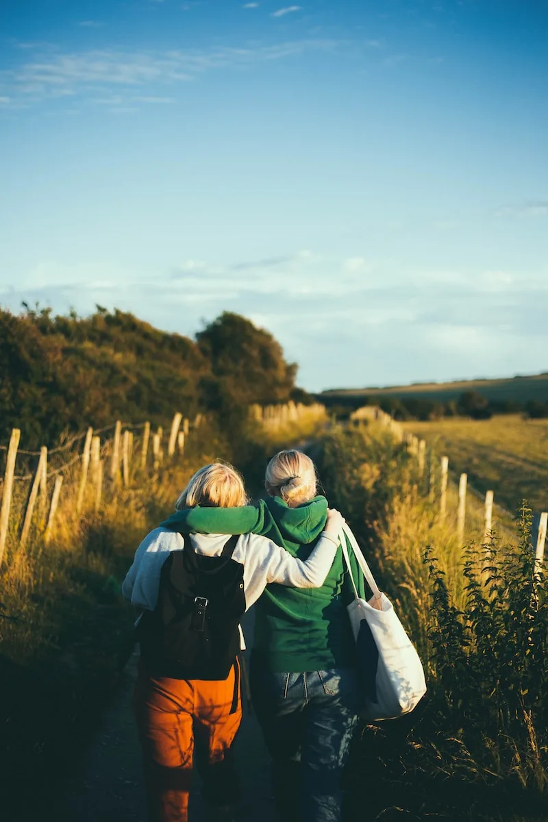 two friends walking together outdoor