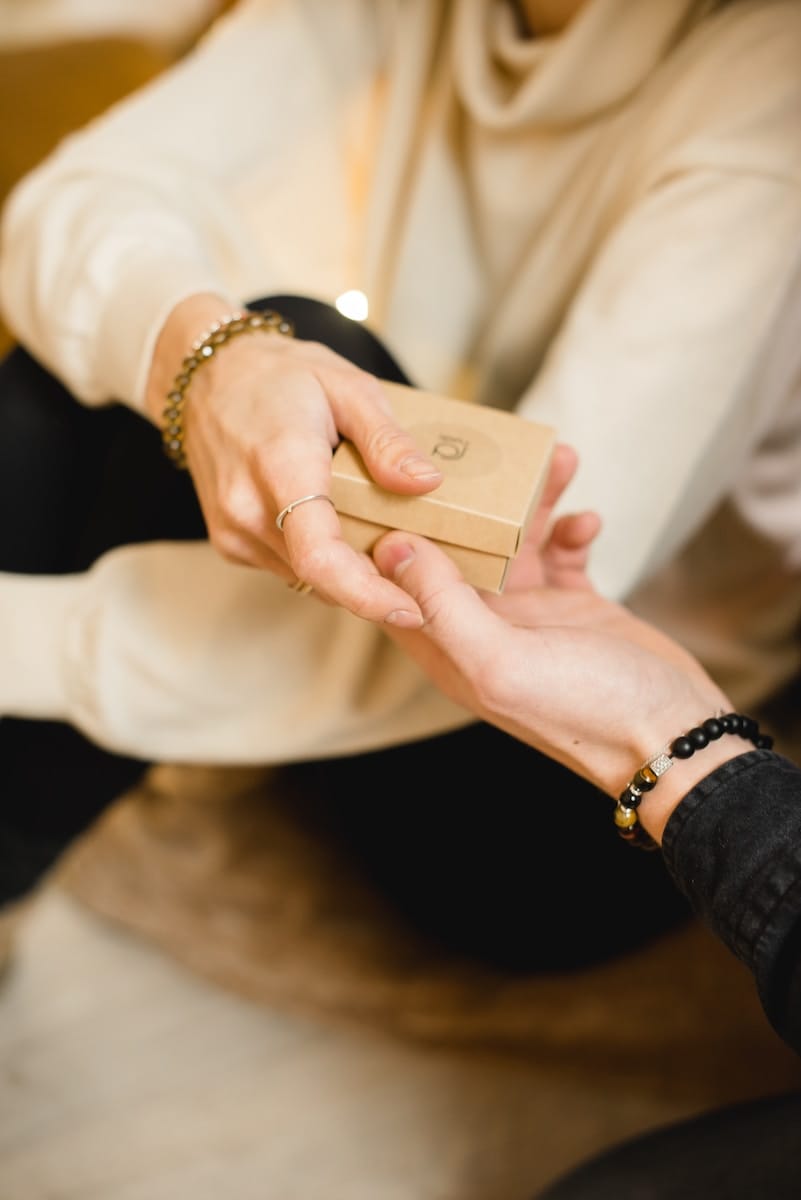 person giving a gift to loved one
