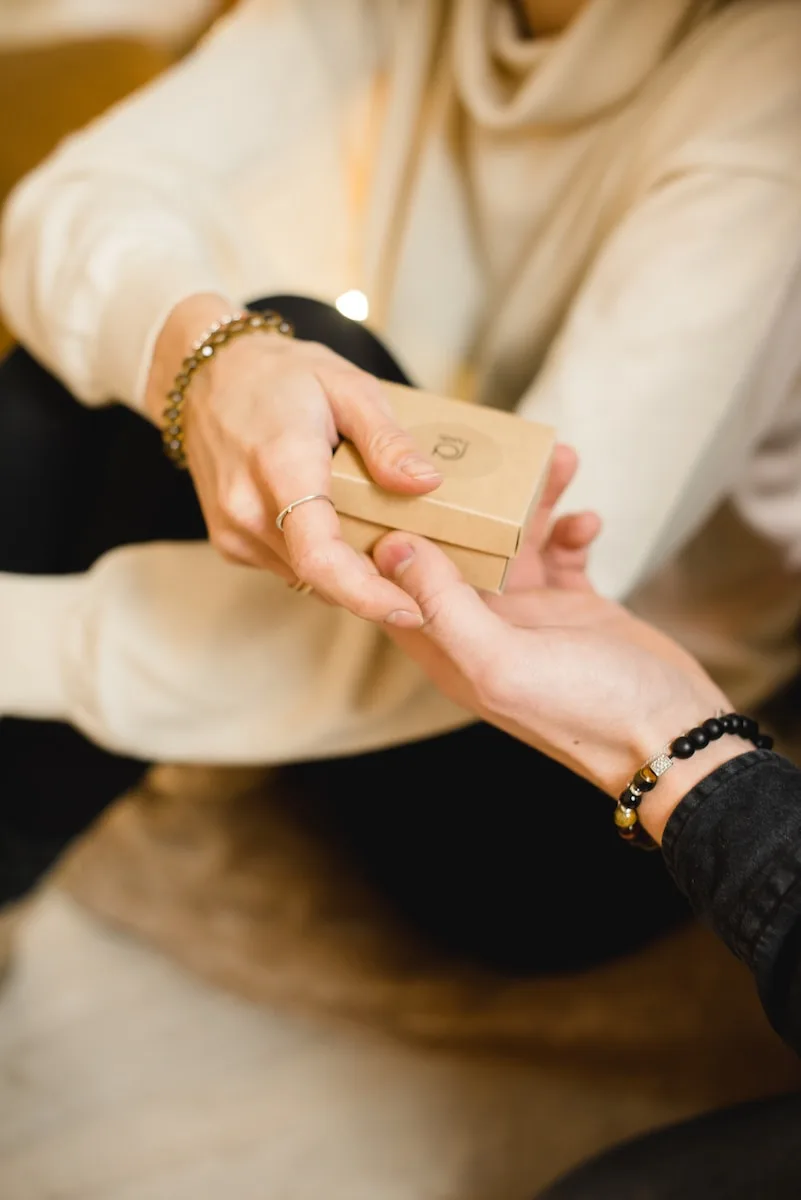 person giving a gift to loved one